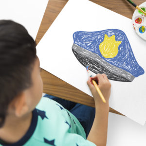 Little boy making a drawing for police officer to show his appreciation.