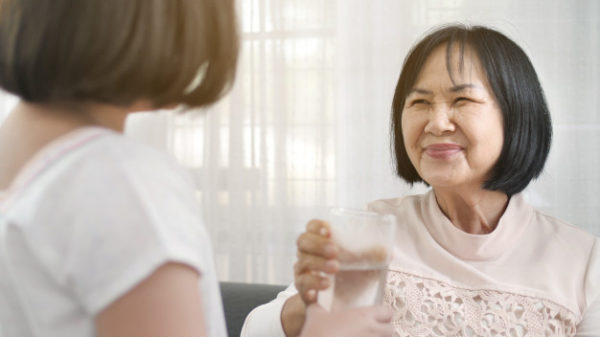 Young Child Helper Bringing Water to Grandmother